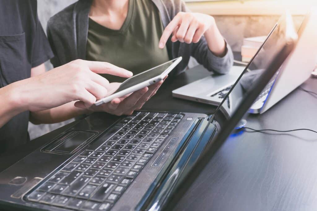 Business partners working together on the same desk