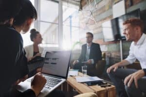 Businesswoman working on laptop in meeting