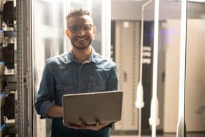 Cheerful server engineer in datacenter room