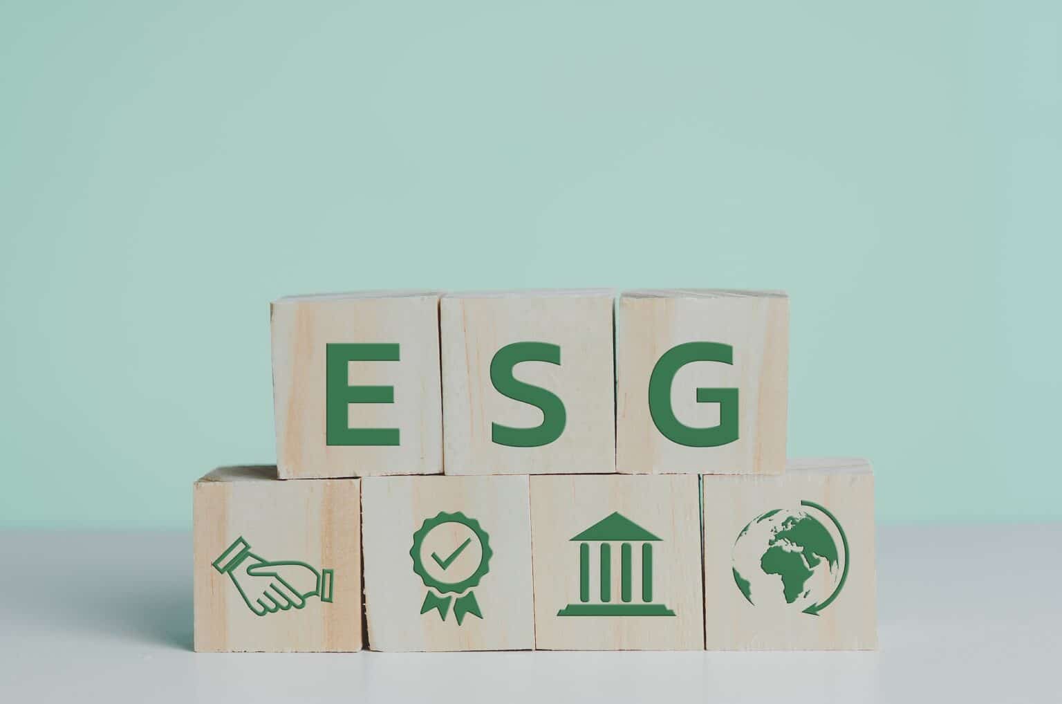 wooden cubes with ESG Environmental Social Governance symbol on table copy space.Business concepts.